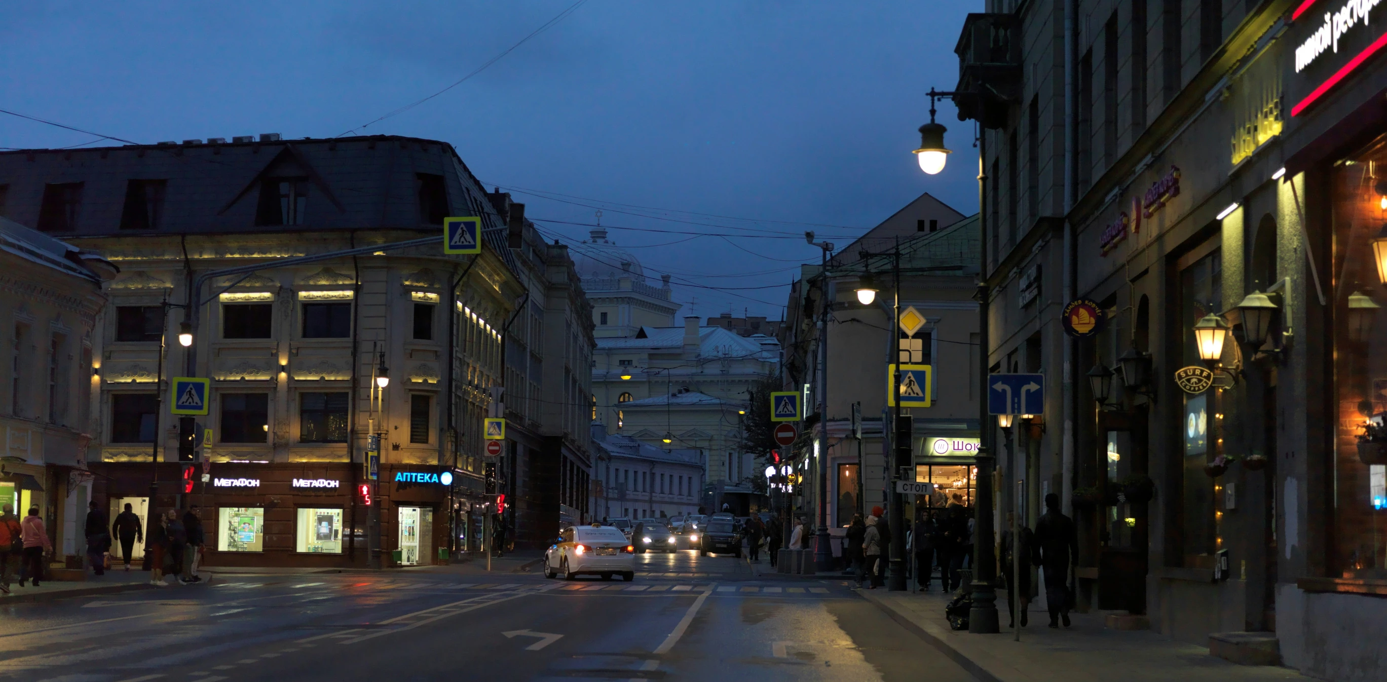 the city street lights shine on the building across from each other