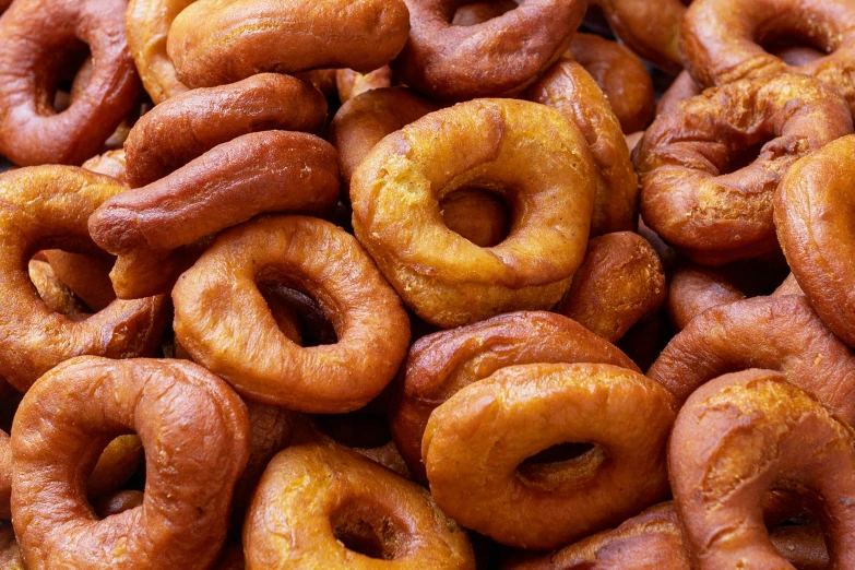 some donuts that have been placed in a pile