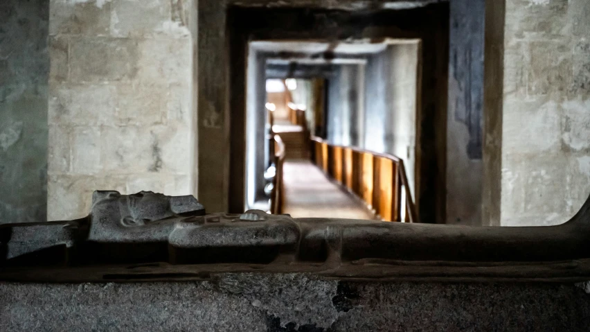 a long hallway leading to a stairway leading into another building