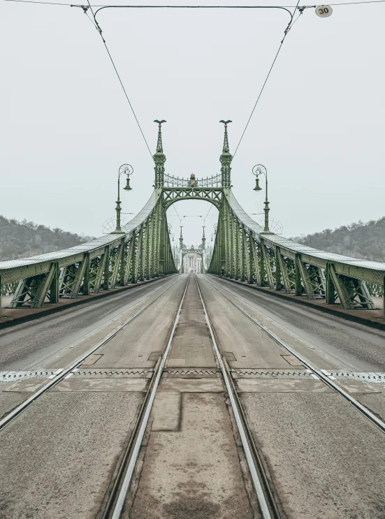 a train crossing over an overhead train bridge