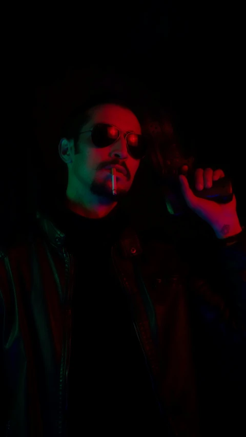the person is smoking in the dark with his eyes closed