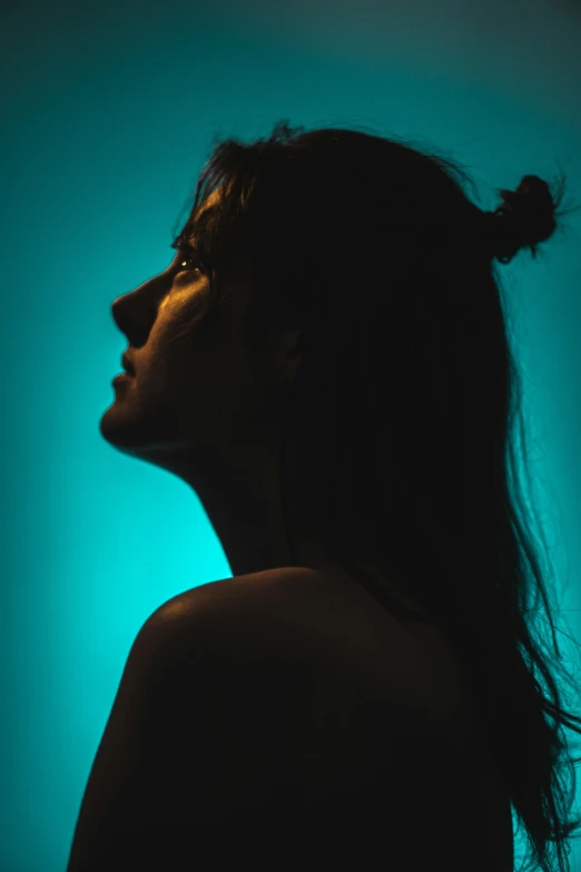 a woman with black hair and a green glow