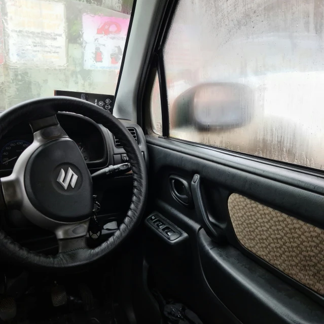 a close up of a steering wheel and dash stick