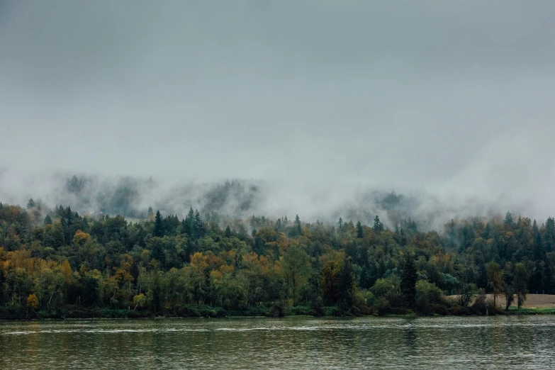 a po of a mountain in the fog from a boat