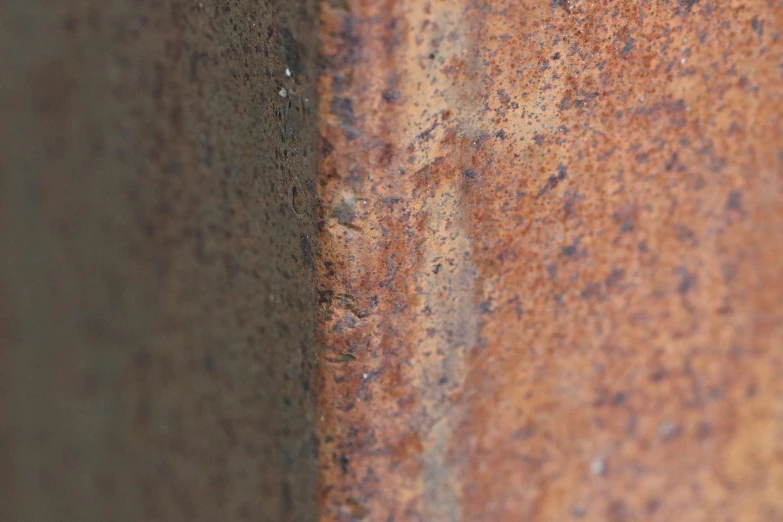 a rusted out metal sheet with s in it