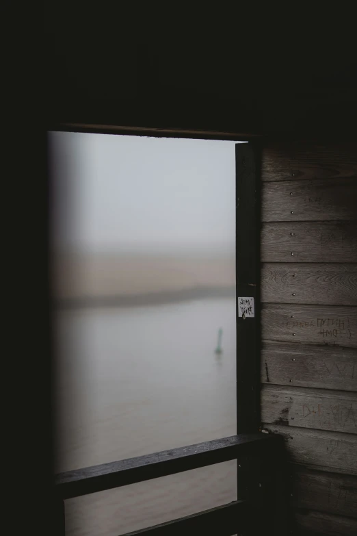 an open window with a lake behind it