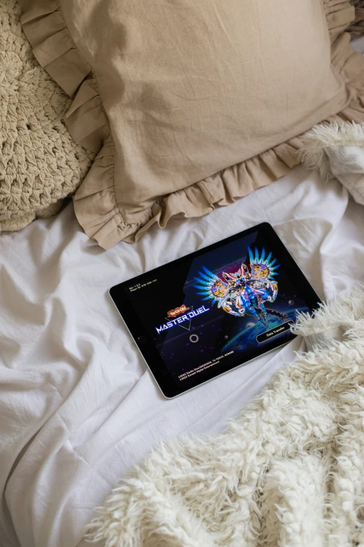 a black laptop computer sitting on top of a white bed