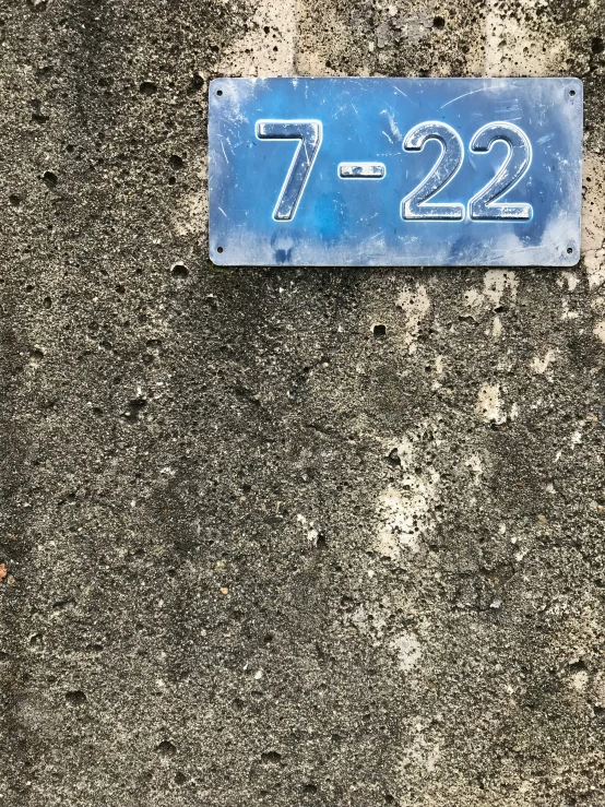 a blue street sign laying on the pavement