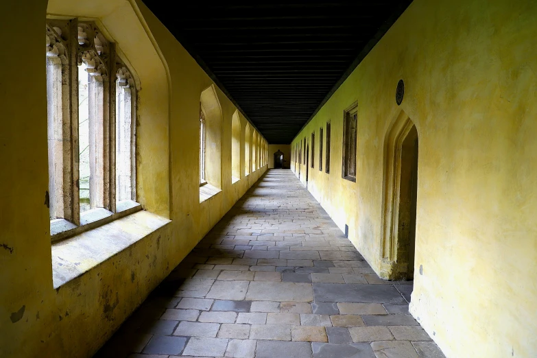 a long hallway with several windows on each side