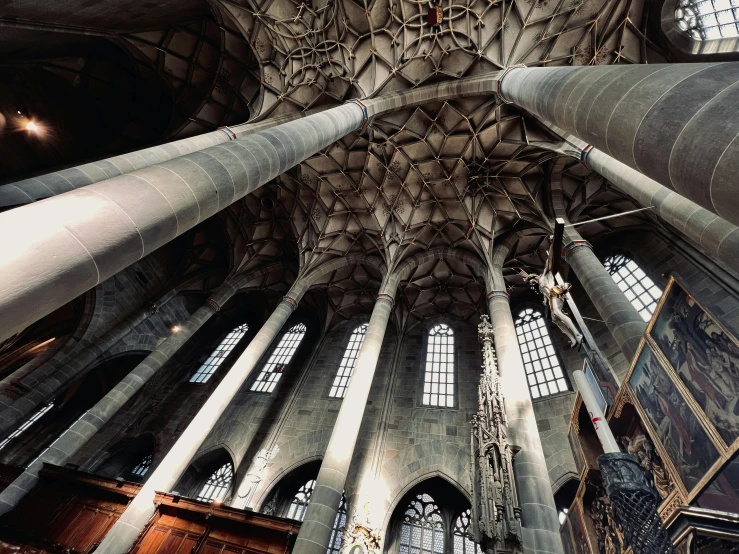 large vaulted ceiling with ornate pillars in a very old church