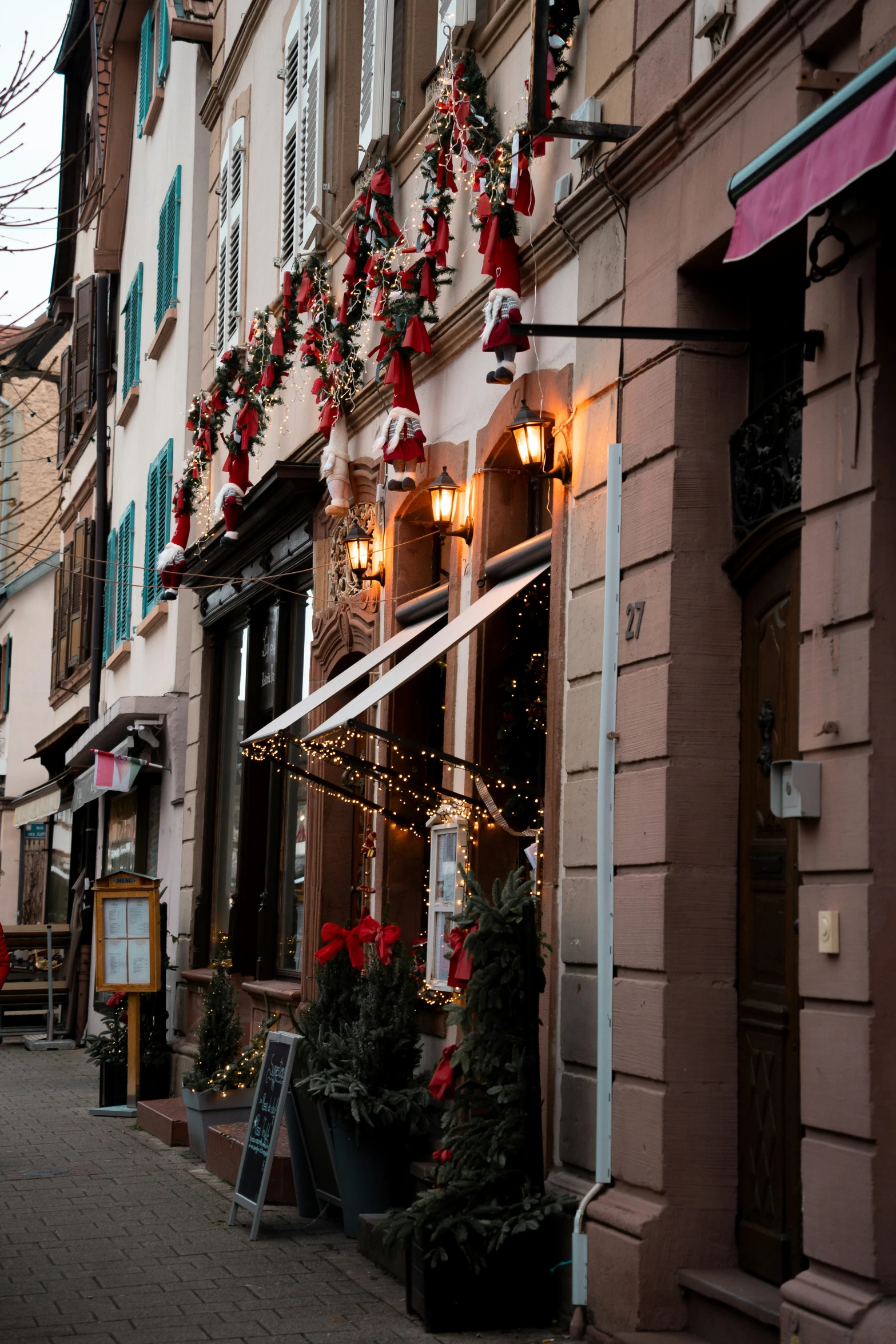 a couple of windows covered with ornaments and string lights