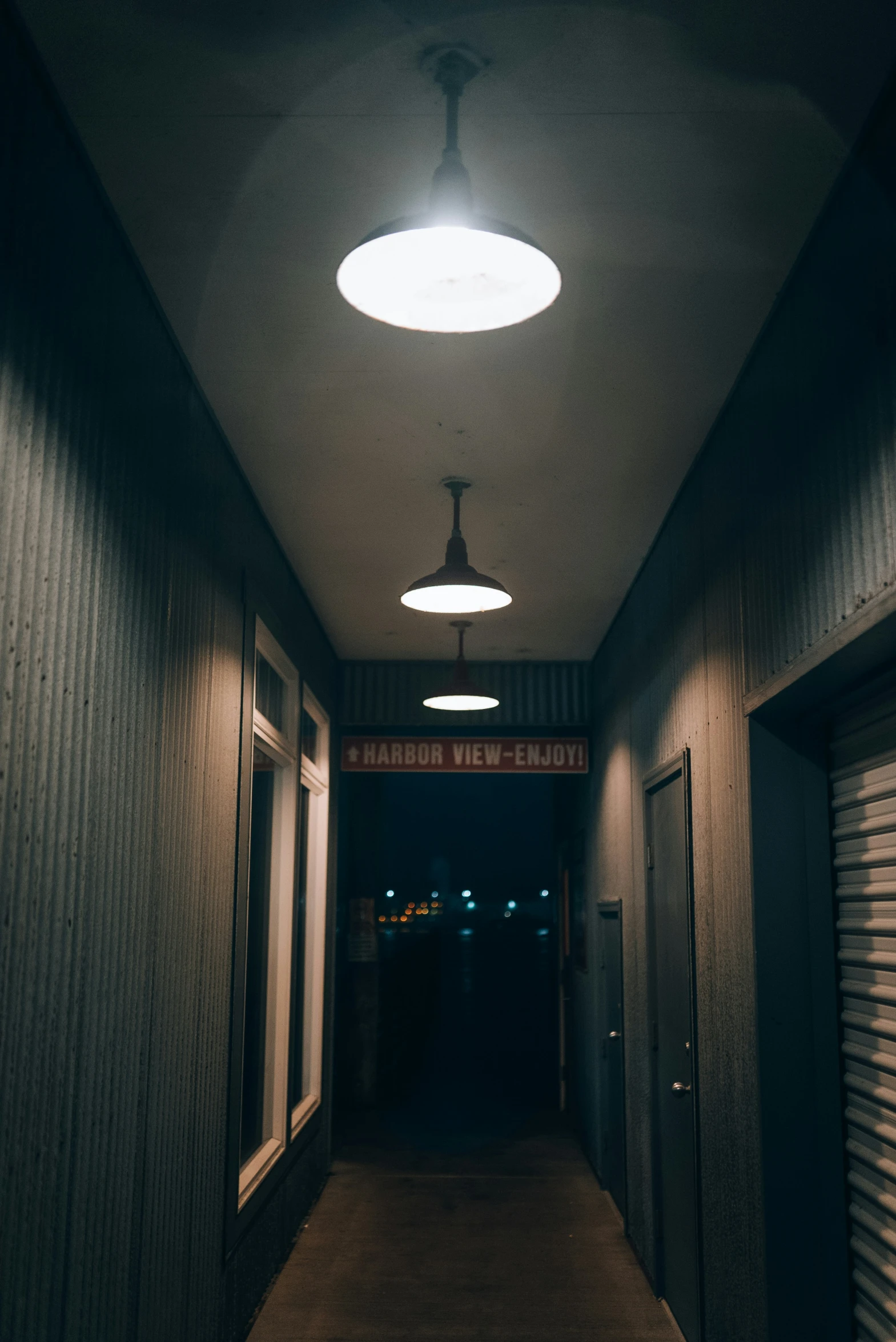 a very long hallway with a light on it