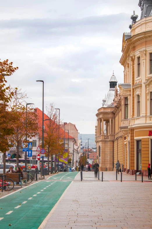 people walking down a city sidewalk in a big town