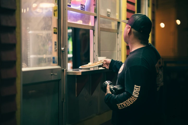 a man is opening the window of a store