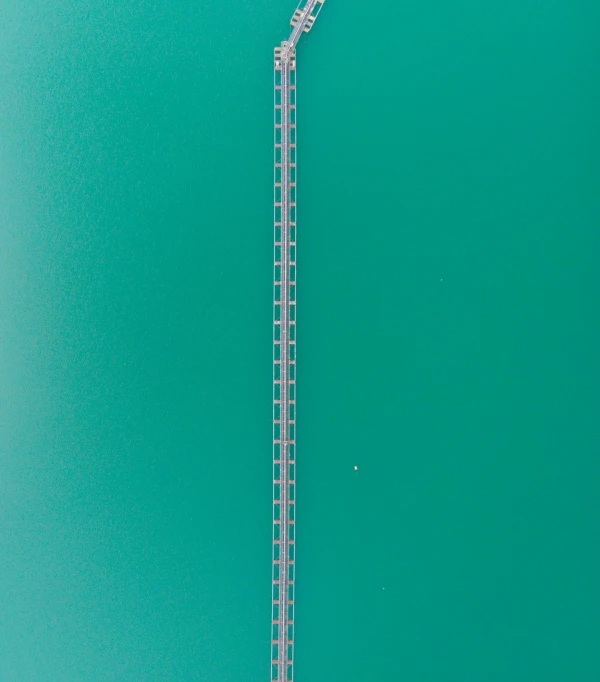 a long dock with a boat next to it