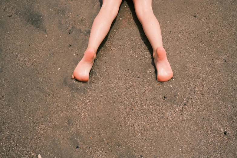 a woman's bare legs and feet are visible from above