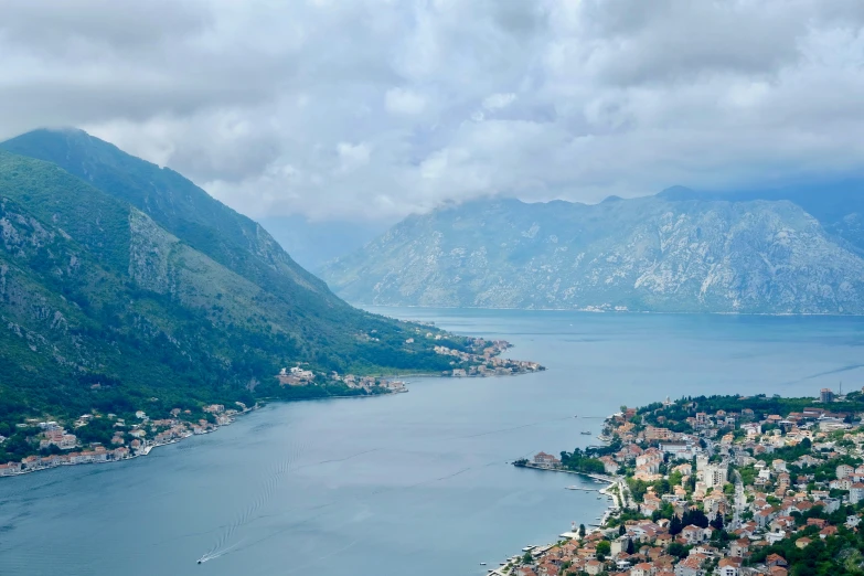 a town is on a mountain lake and mountains are visible