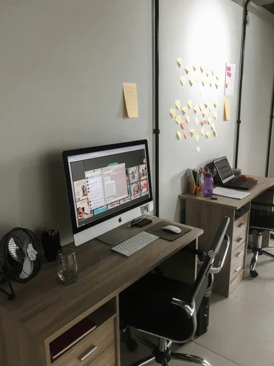 a desk that has two computers on it