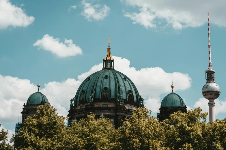 the dome of a building has a red spire in it