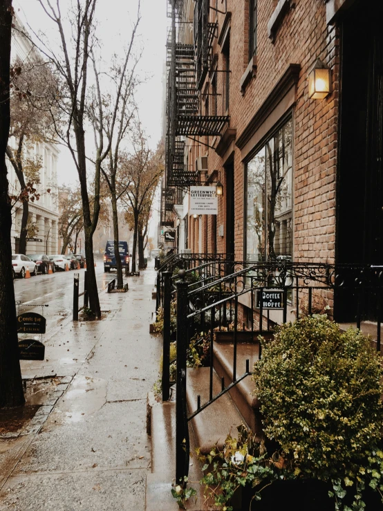 a city street with brick buildings and a fire escape