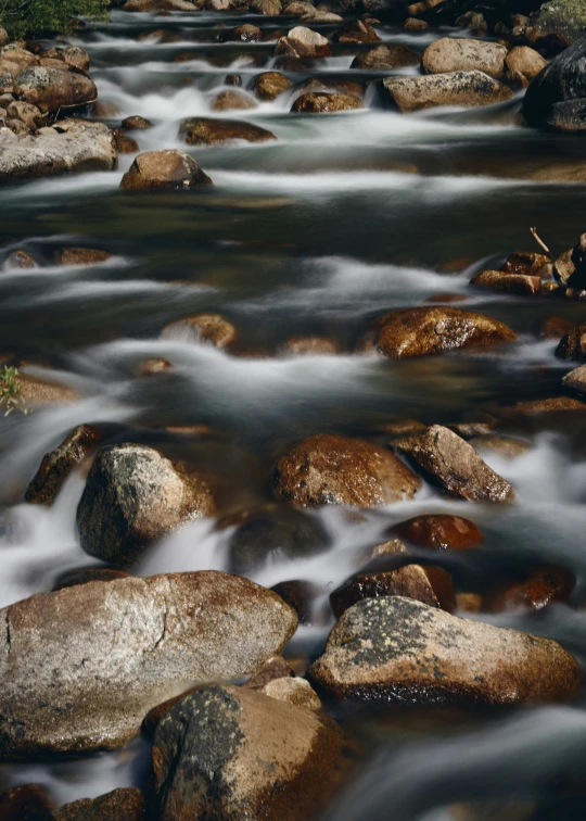 a creek running through some rocks and water