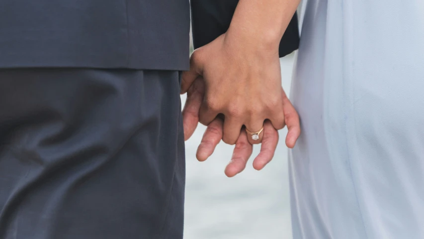 closeup of a bride and groom holding hands