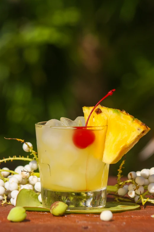 the pineapple cocktail has been garnished with cherries