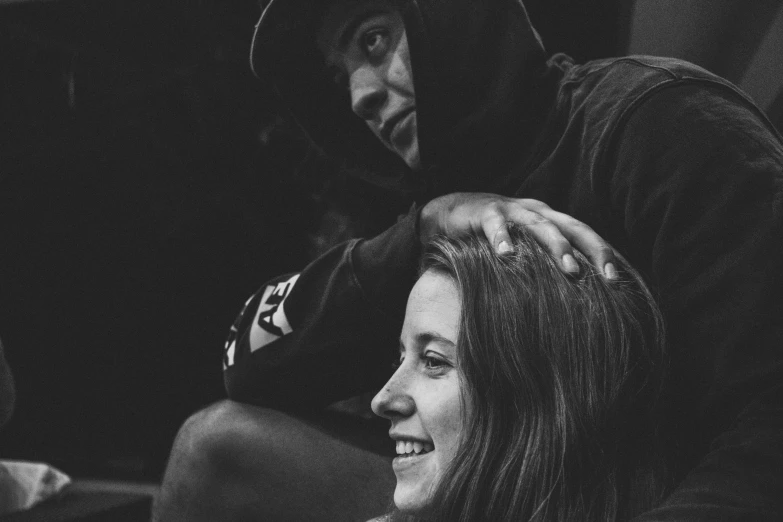 a young couple sits together at the soccer game