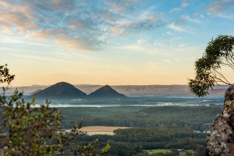 a view of mountains from the top of a cliff