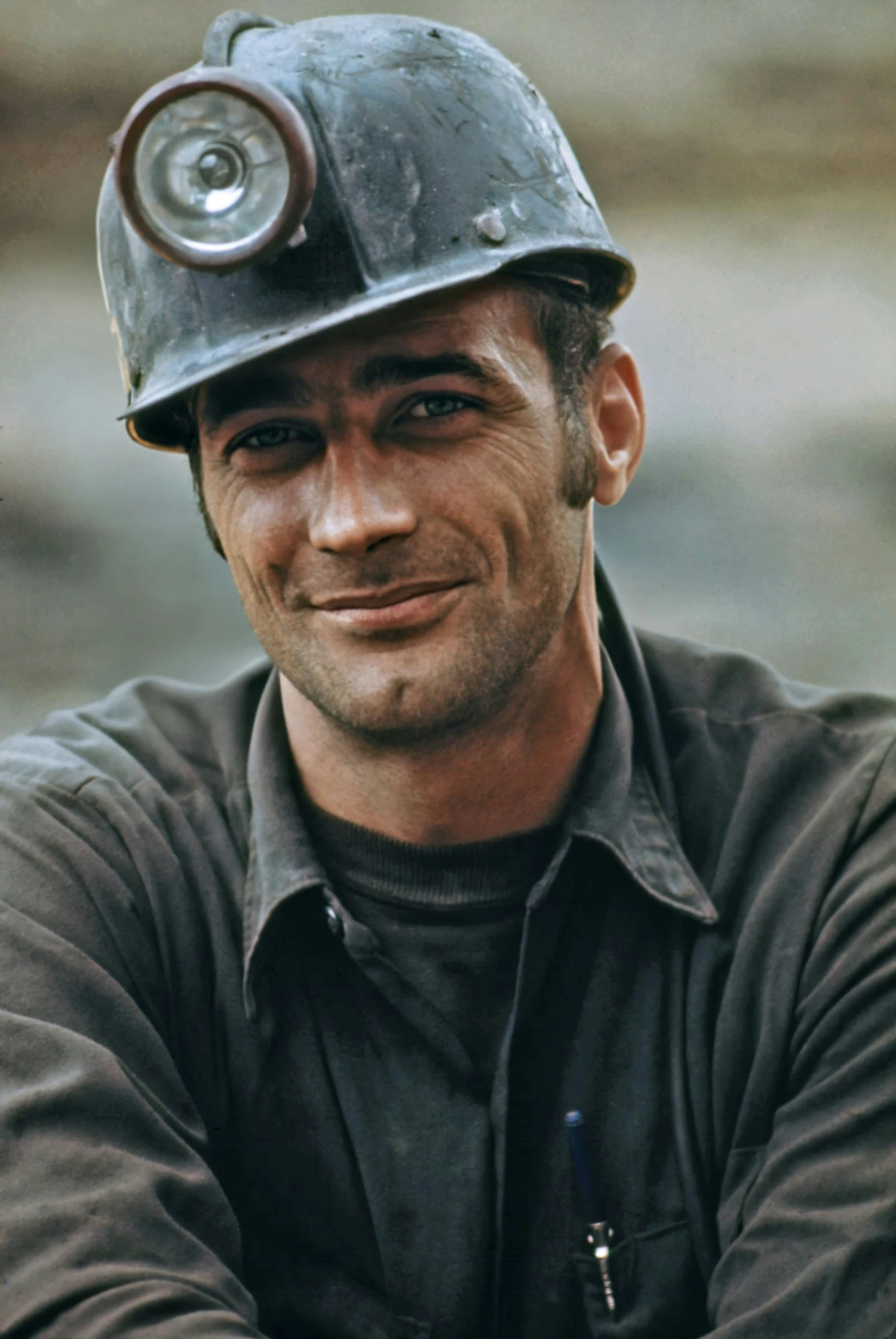 a man wearing a helmet with an eye patch and a metal object on it's head