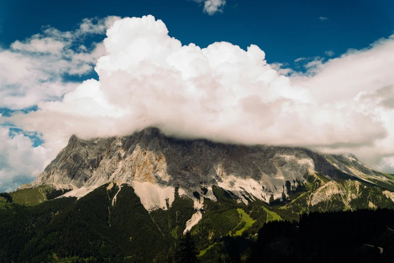 a mountain is shown covered in some clouds