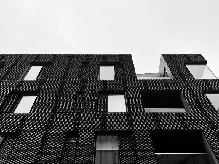 a tall building with windows that are covered in wavy lines