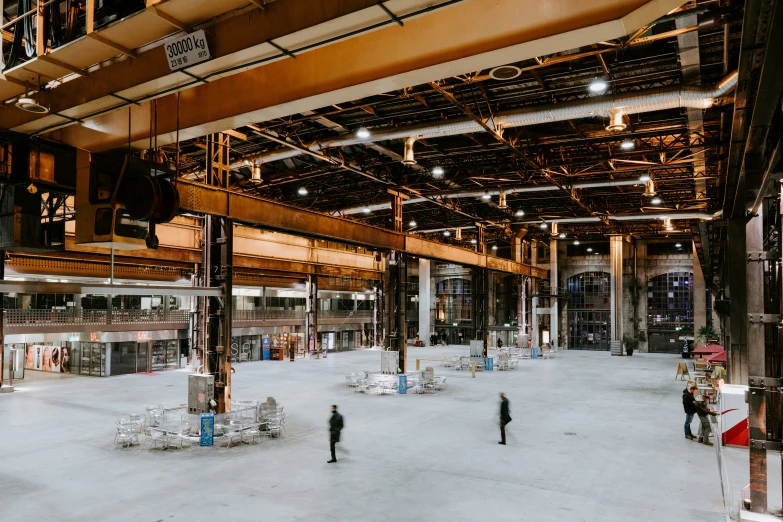 a large open building with people walking around it