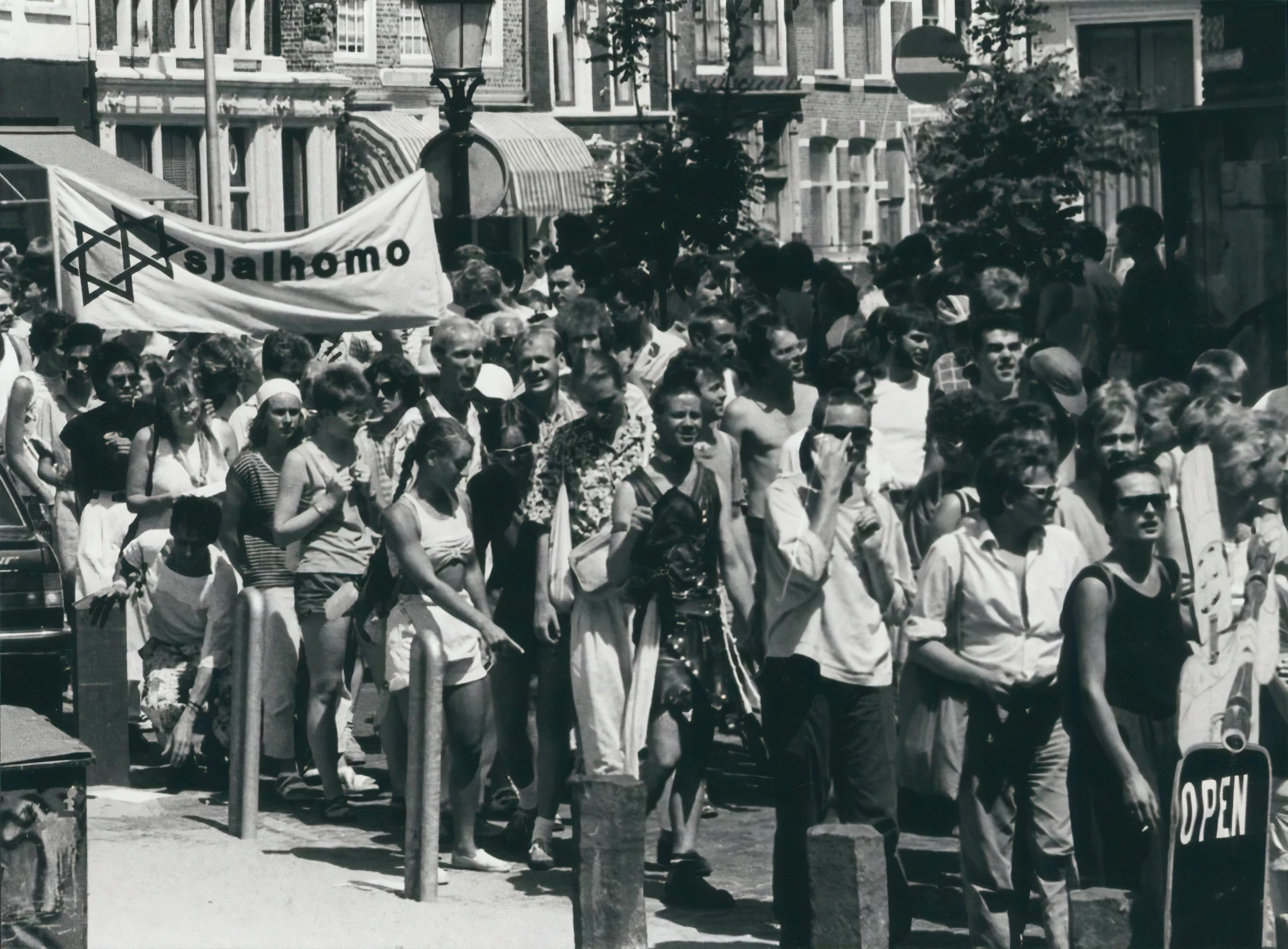 some people walking down a crowded street with banners