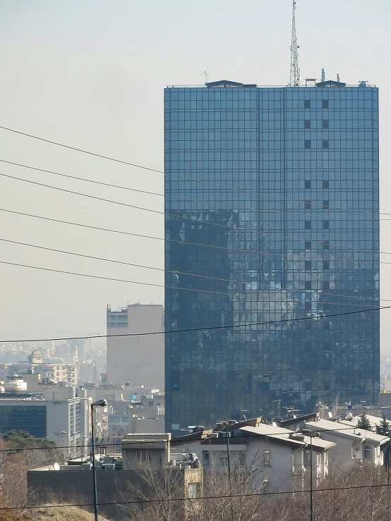 a building sits in the background as power lines cross over the city