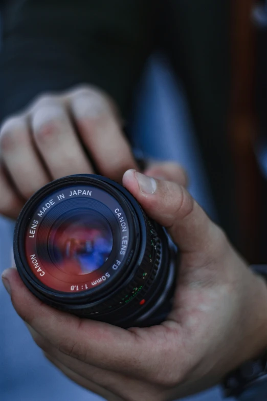 man holding an analog camera in his hand