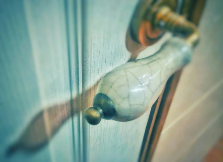 the handle of a wooden door with glass