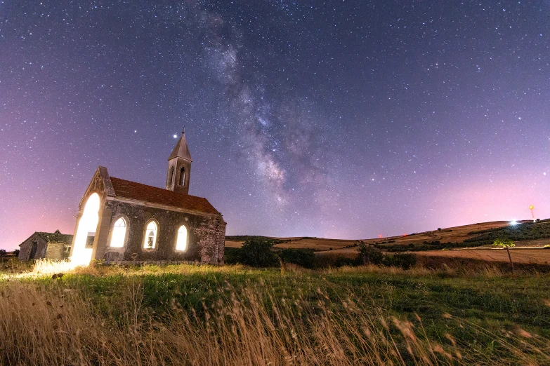 a church sitting in the middle of a field