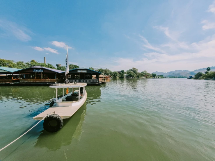 a small boat in the water near some cabins