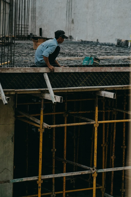 a person standing on a ledge next to a building