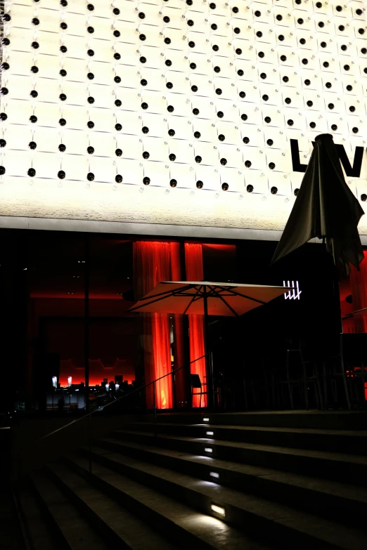 some steps outside a large building with an umbrella