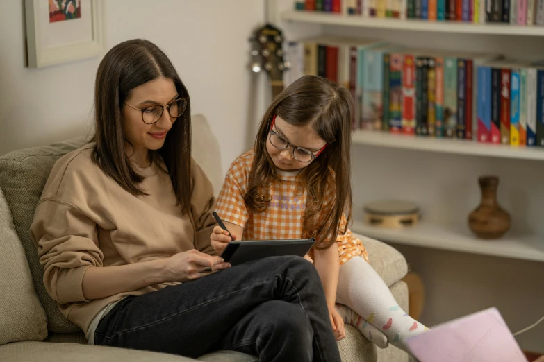 a woman and a child sitting together on a couch