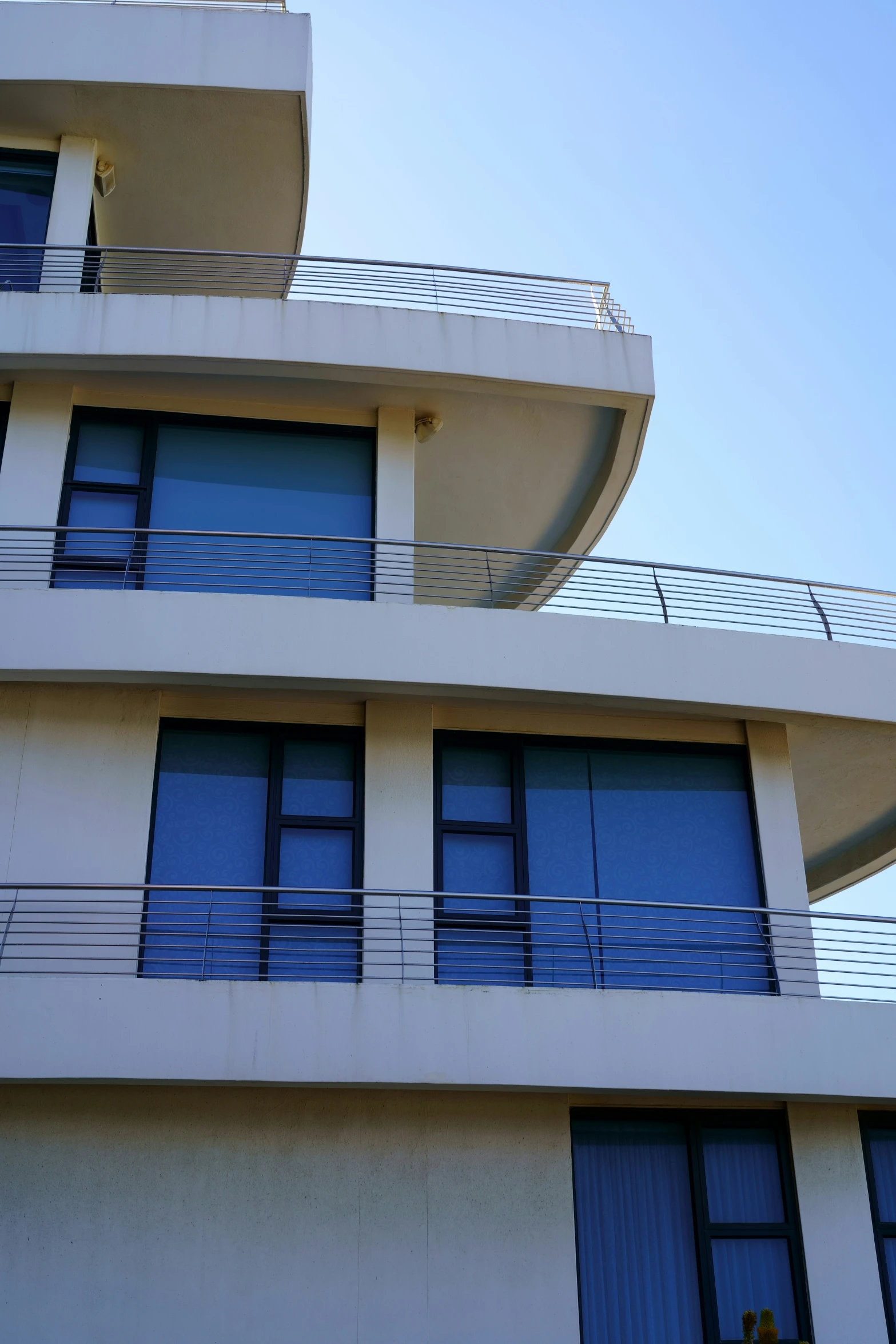 the top balcony of an apartment building with balcony railing