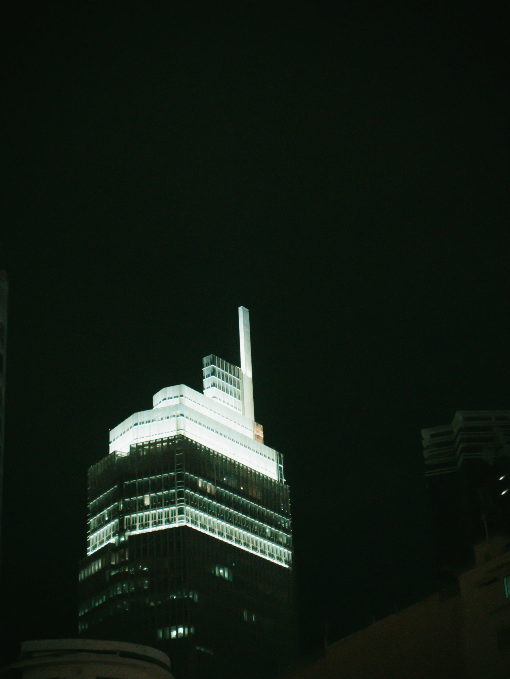 dark picture of some buildings and very tall one