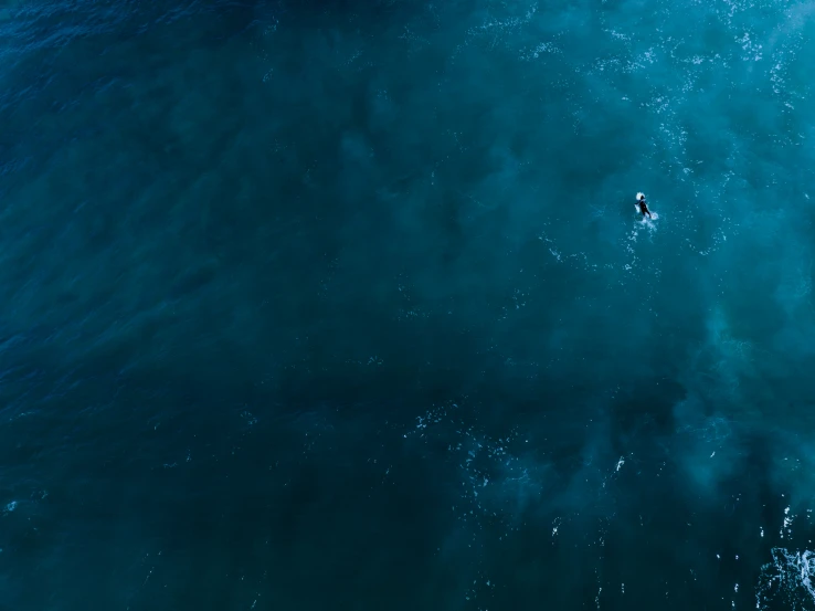 a surfer is in the middle of an ocean
