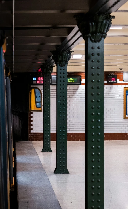 an empty subway station with a train sitting inside