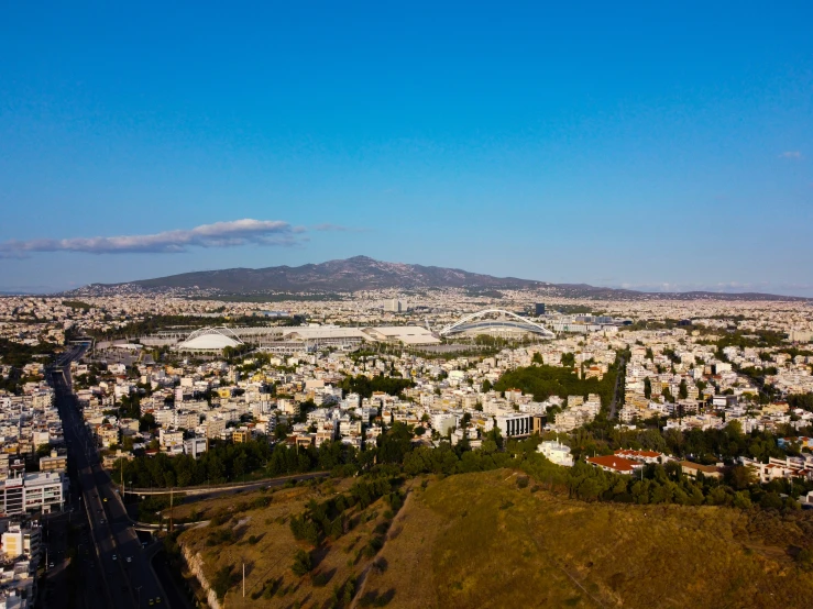 an aerial view of the city with the mountain in the distance