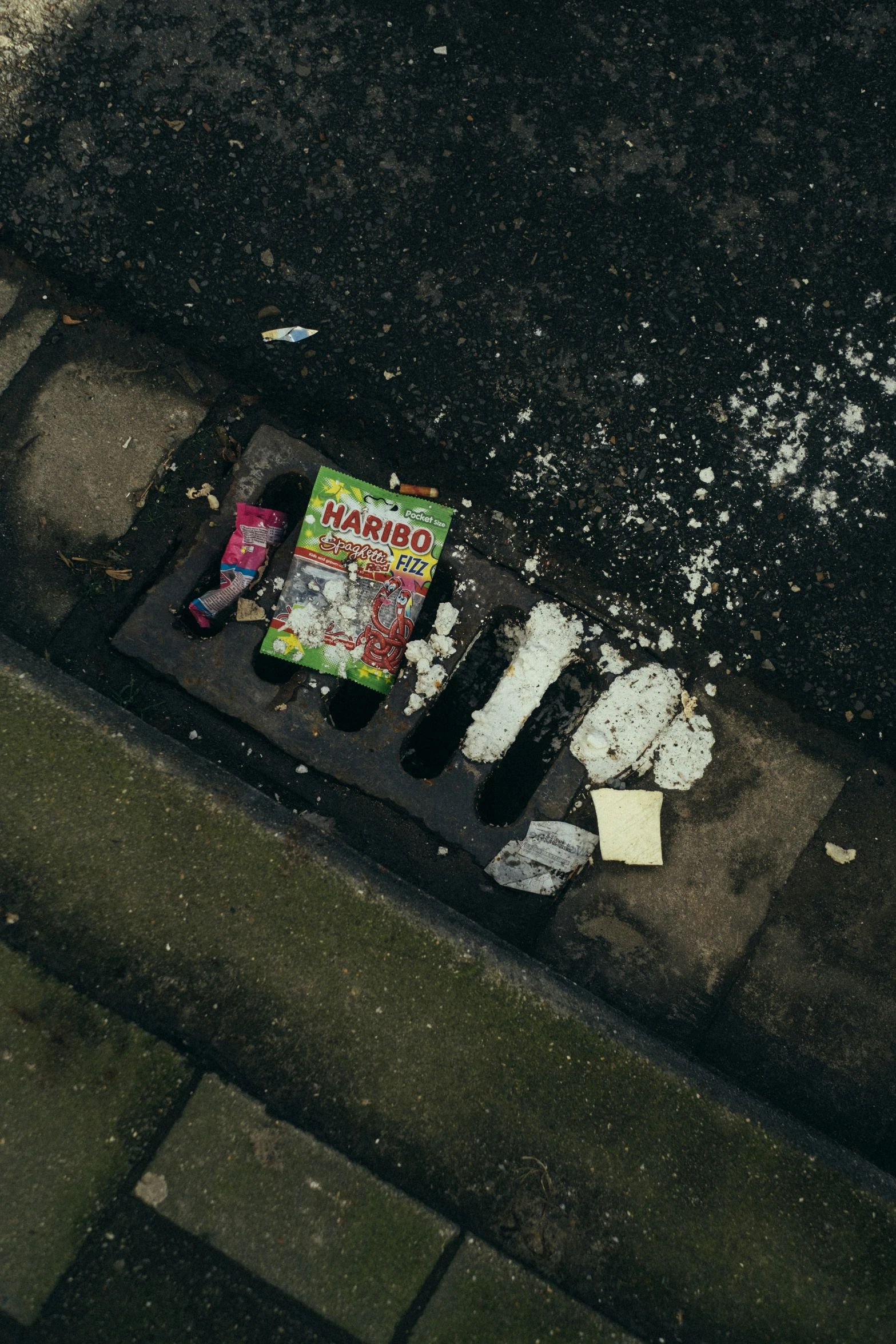 an old broken book and some trash on the side of a road