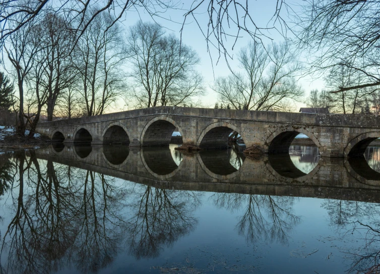 a stone bridge over a large lake