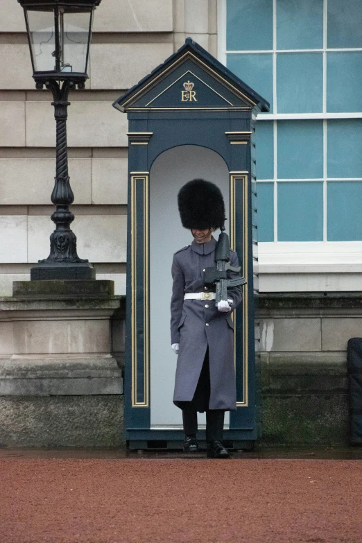 a soldier with an overcoat in front of a building